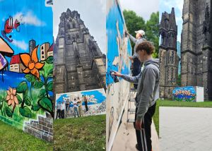 Jugendliche mit Spraydose in der Hand gestalten den Container vor St. Nikolai.